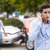 Teenage Driver Making Phone Call After Car Accident